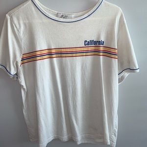 White T-shirt with some colors.